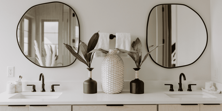 Bathroom Remodel in Des Moines with Rounded Mirror and Double Vanity