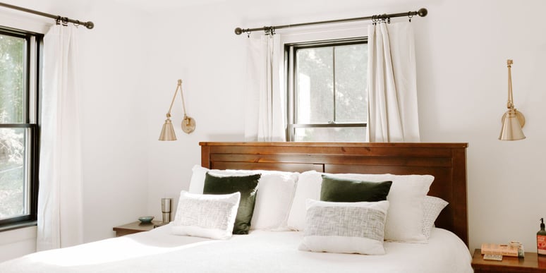 Remodeled bedroom in Des Moines featuring black windows and white walls