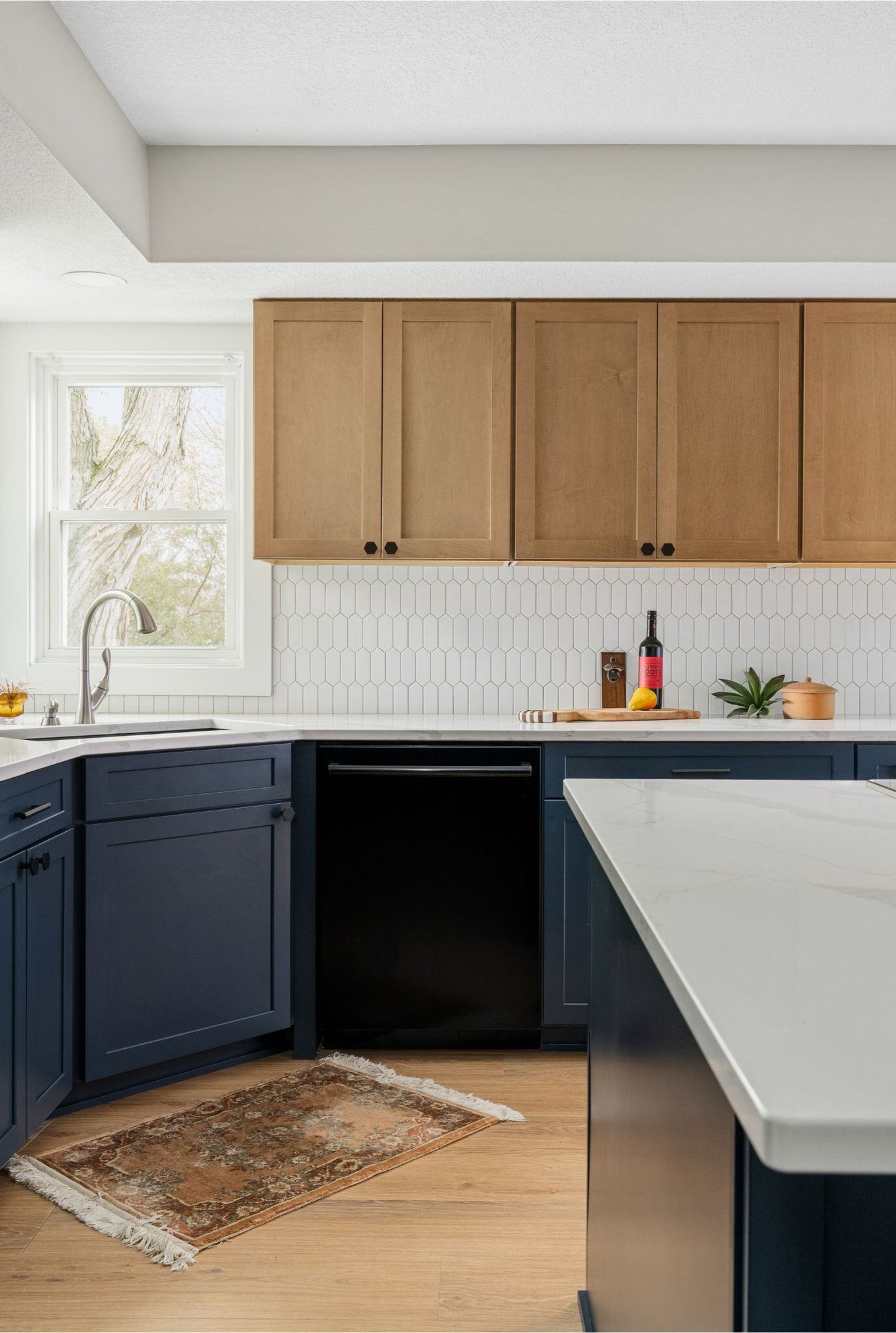 Remodeled kitchen in des moines with blue lower cabinets and sandalwood upper cabinets