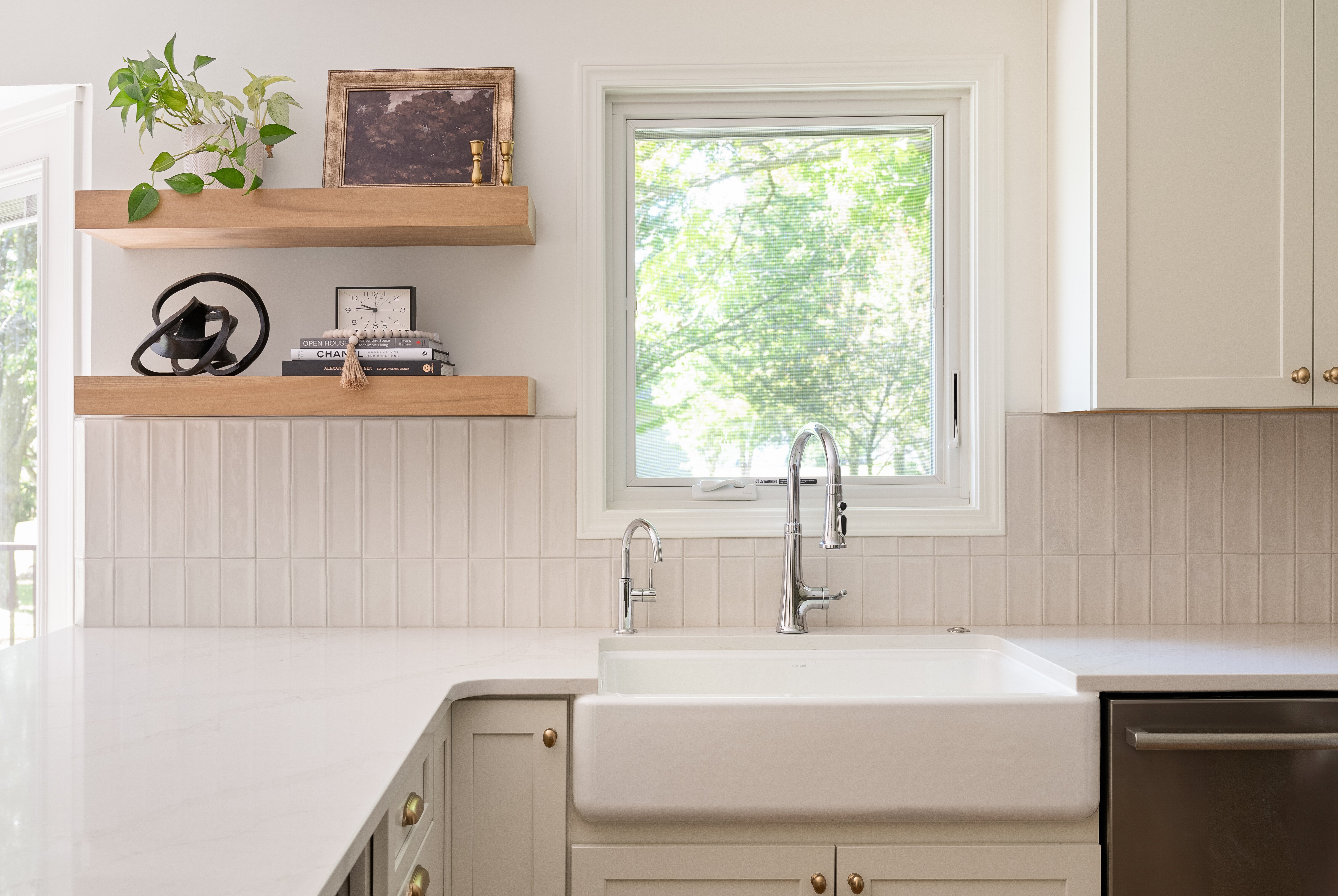 Modern white kitchen remodel in des moines iowa with open wood shelves and natural light