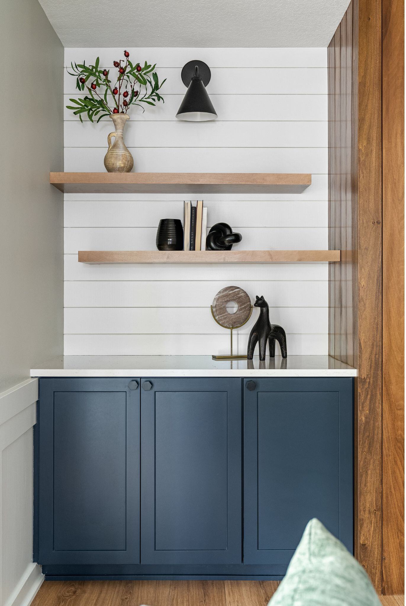 Fireplace shelving renovation with blue lower cabinets, and open shelves on top