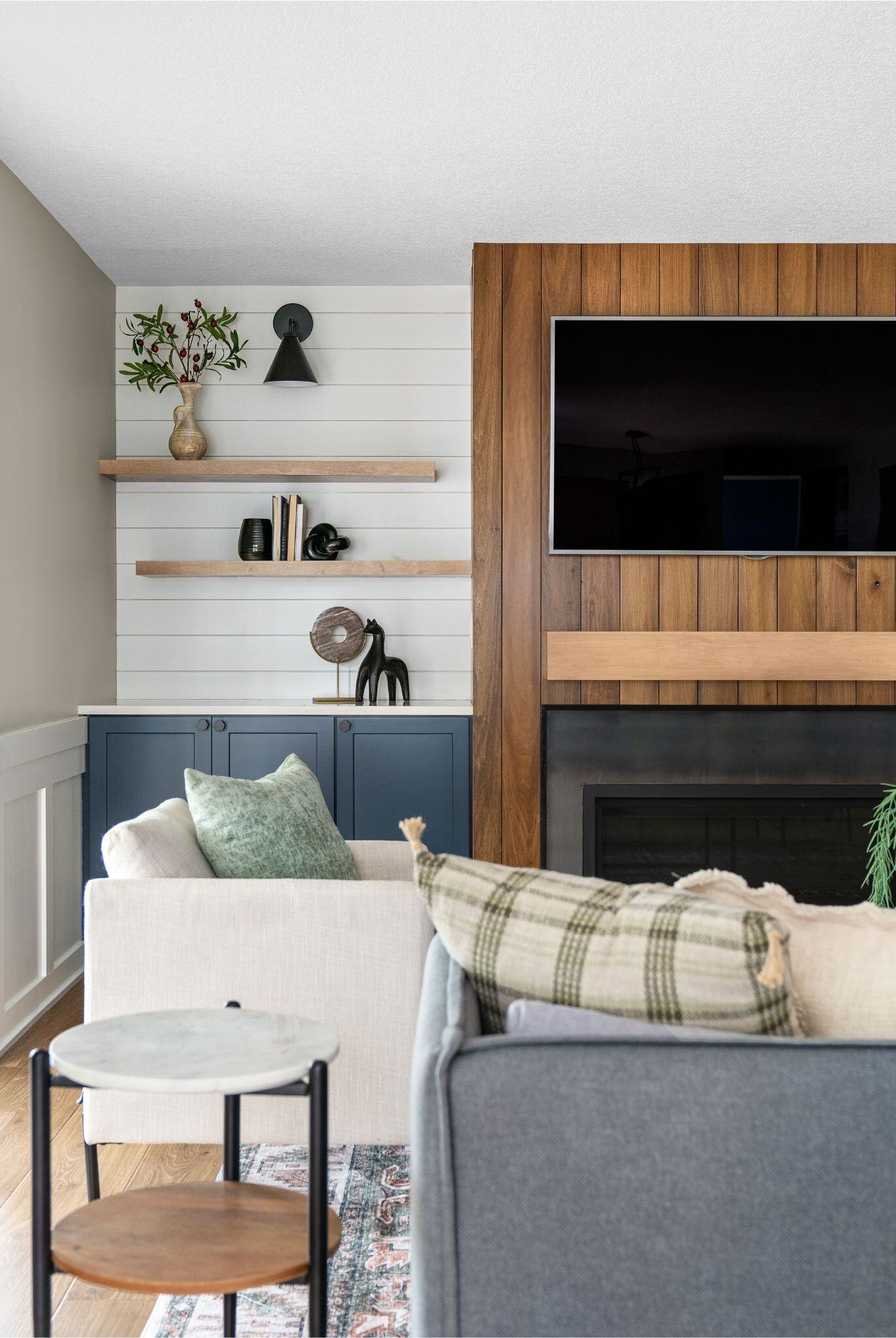 Living room remodel with wooden fireplace finish and surrounding shelving