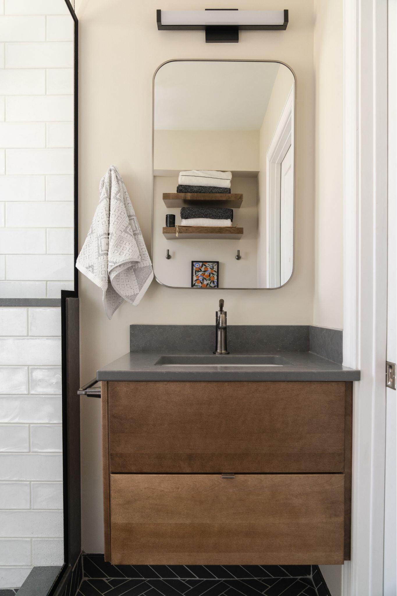 Floating bathroom vanity in a remodeled bathroom with a modern, rustic style in des moines iowa