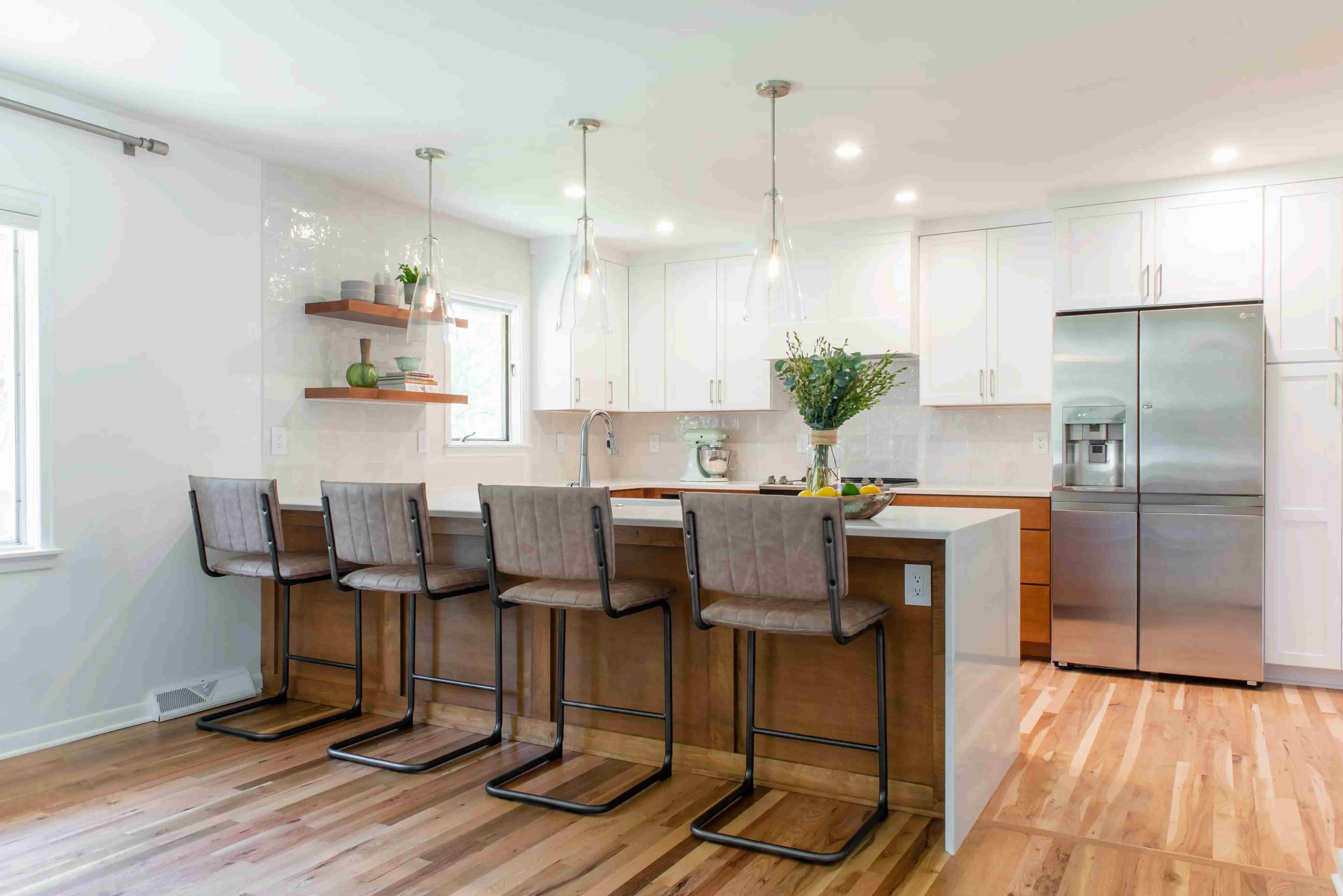 Kitchen Remodel with White Cabinets and Wood Under Island and Glass Pendants in Des Moines, Iowa