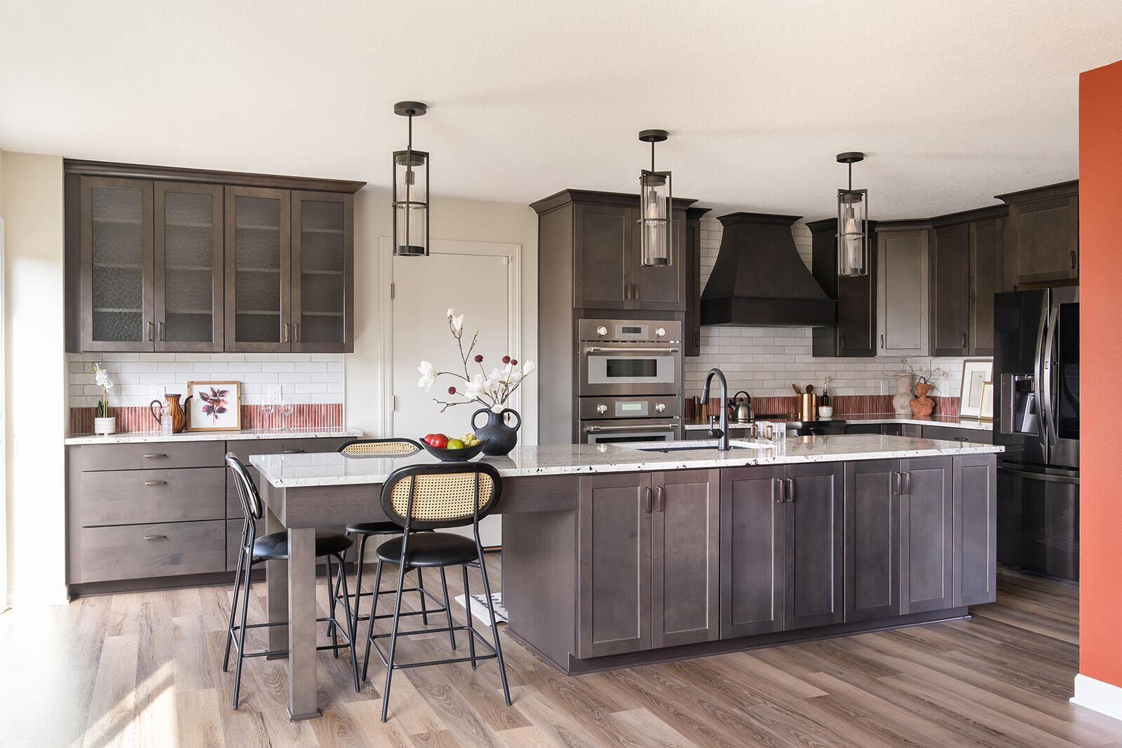 Wide shot of full kitchen renovation in Des Moines, IA area with large kitchen island, coffee bar, and bar stool seating