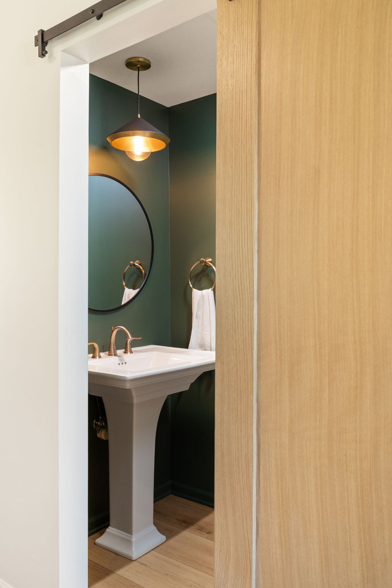 Bathroom remodel with barn door and green walls