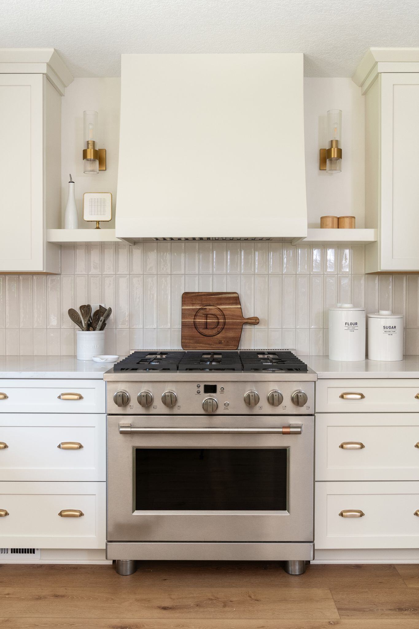 Kitchen remodel featuring stainless steel oven and white cabinets