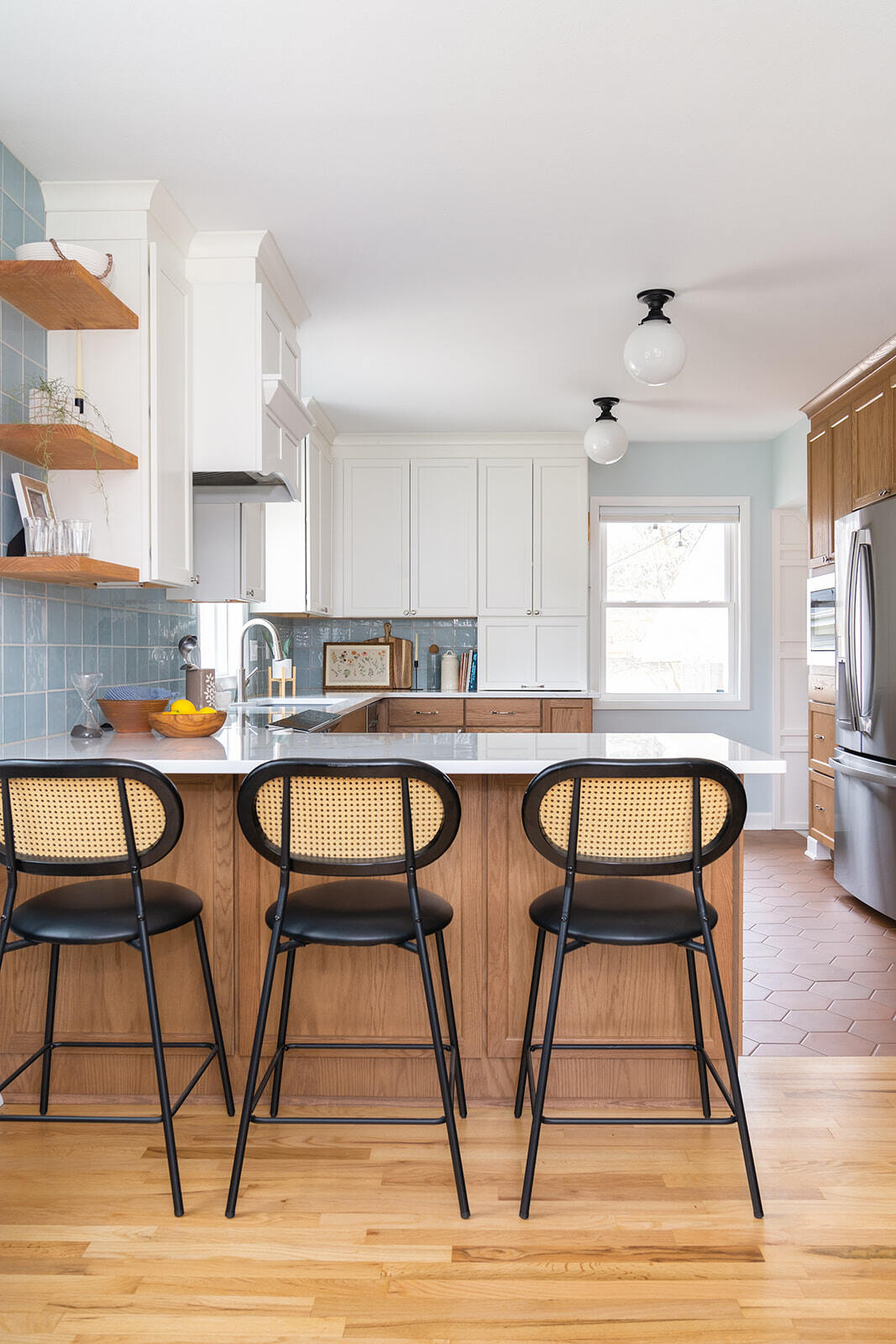 Remodeled Kitchen with light wood flooring and bar seating and stainless steel appliances