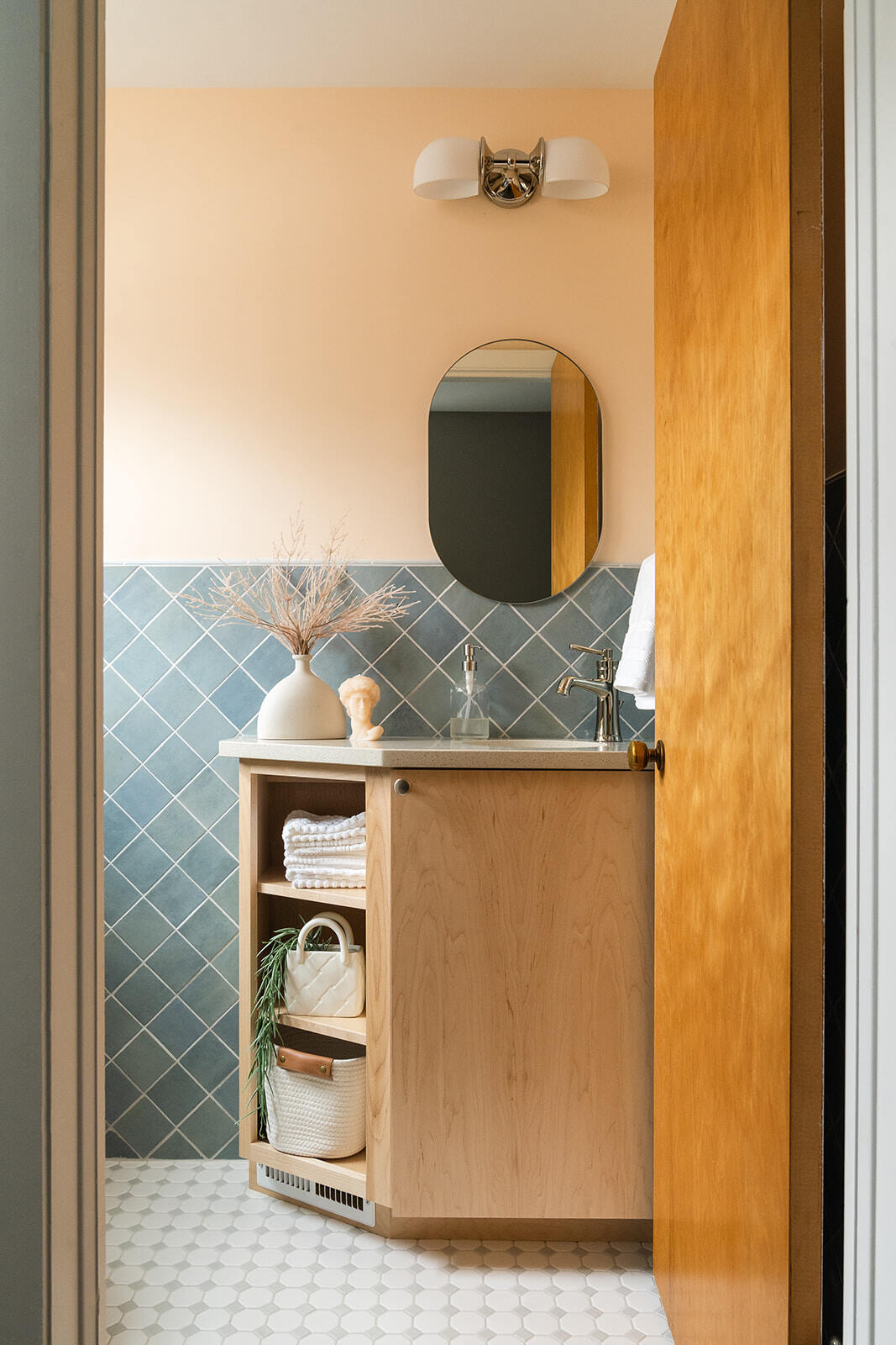 Bathroom remodel in des moines with light wood vanity and blue backsplash