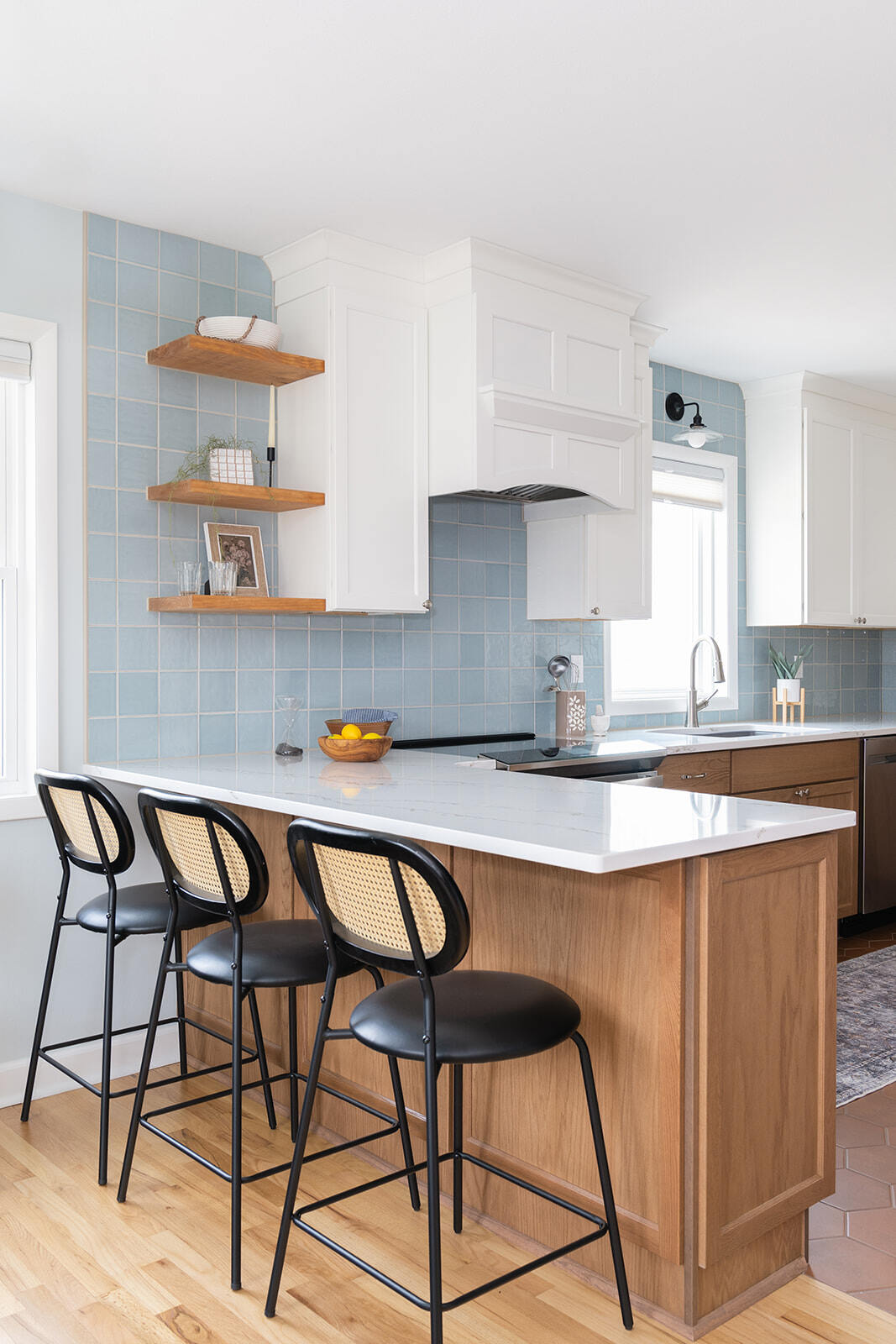 Kitchen Remodel in Des Moines with blue and white color pallette featuring bar stool seating